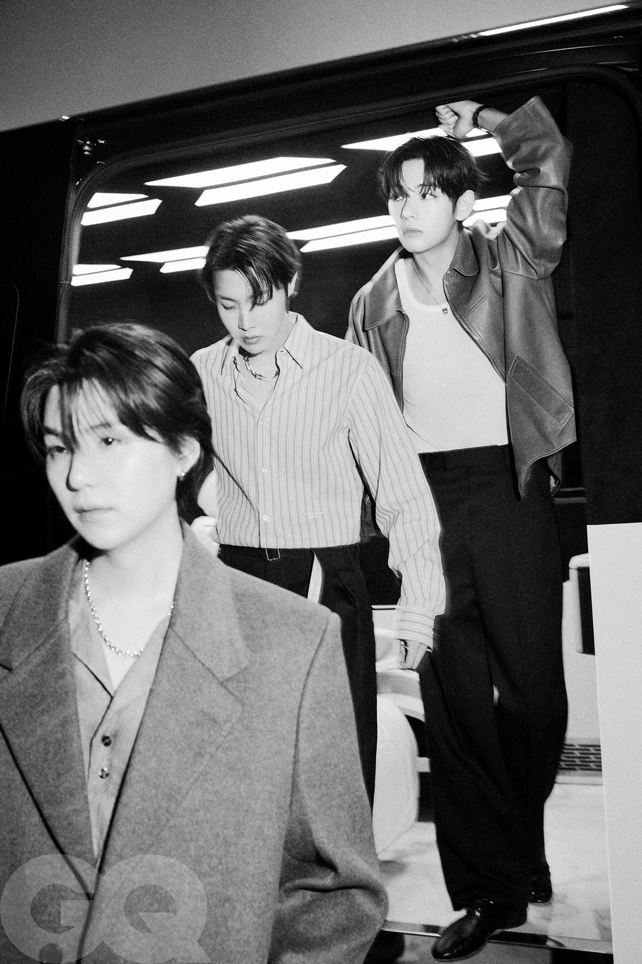 BTS members in a black and white editorial photograph for GQ March 2026