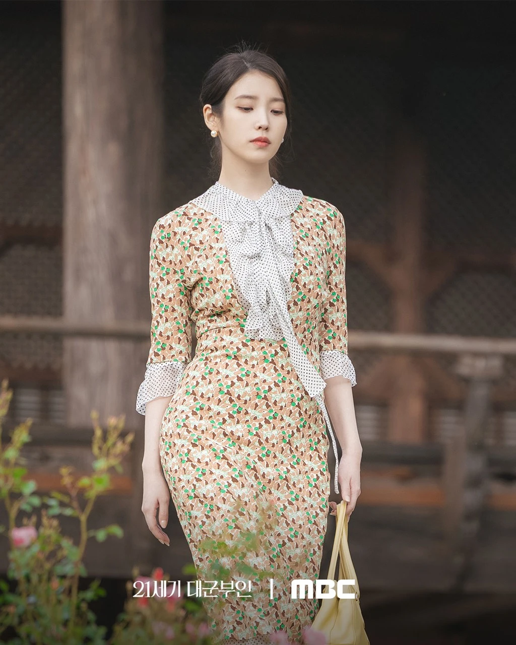IU as Sung Hee Joo in Perfect Crown, wearing elegant attire as a chaebol heiress