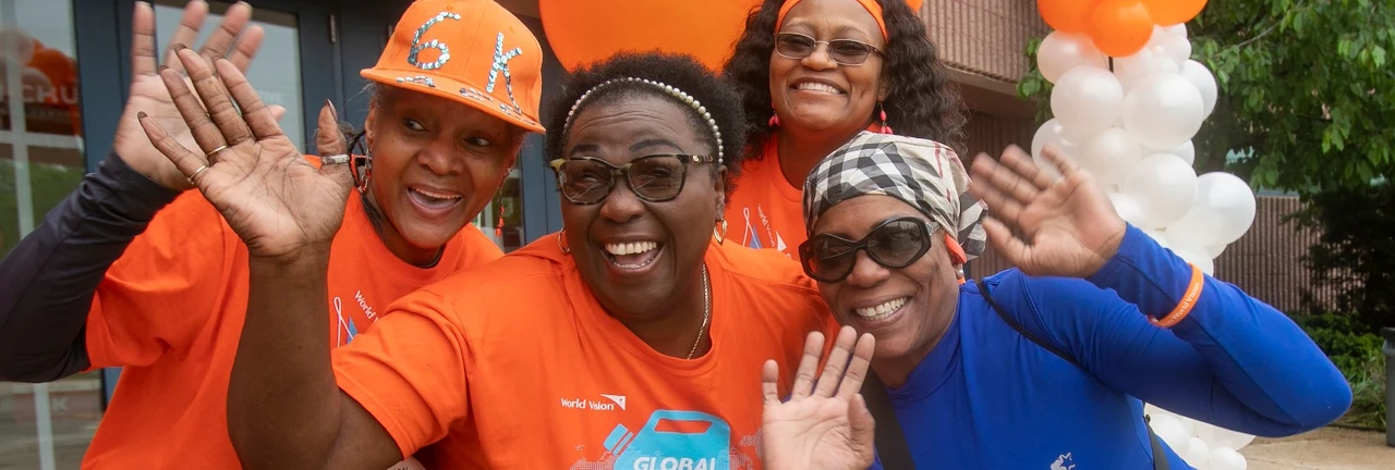 Participants at a World Vision Global 6K for Water event wearing branded orange shirts
