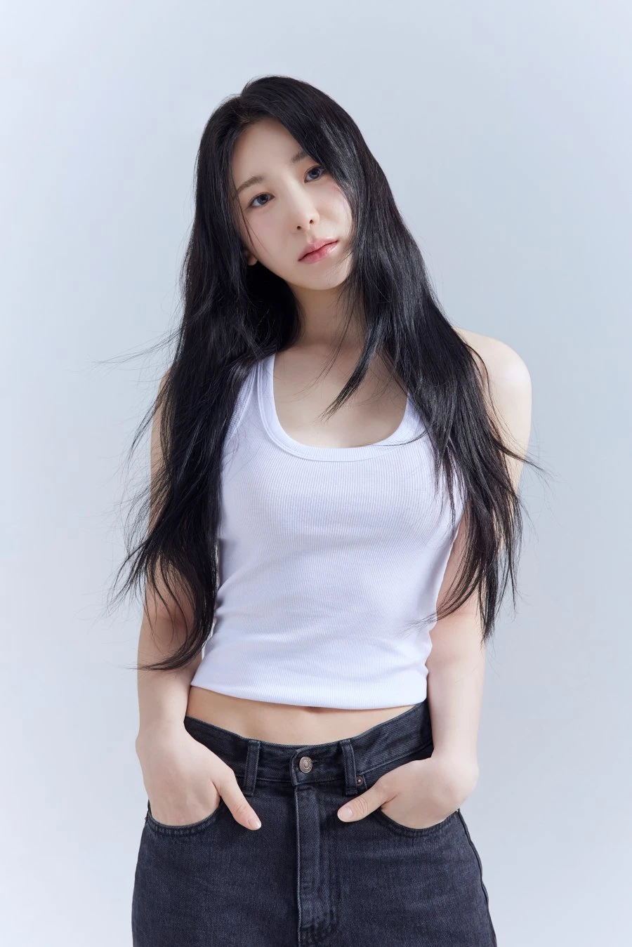 Lee Chae Yeon in a white sleeveless top and dark jeans in an official profile photo released after signing with DOD