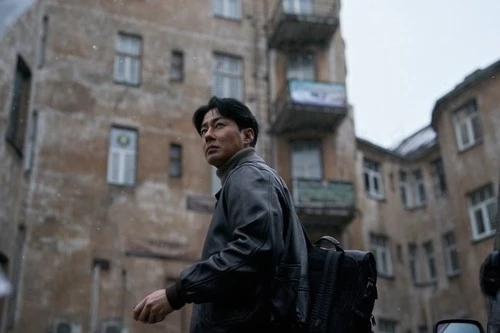Zo In-sung in a Humint production still walking through a bleak urban setting