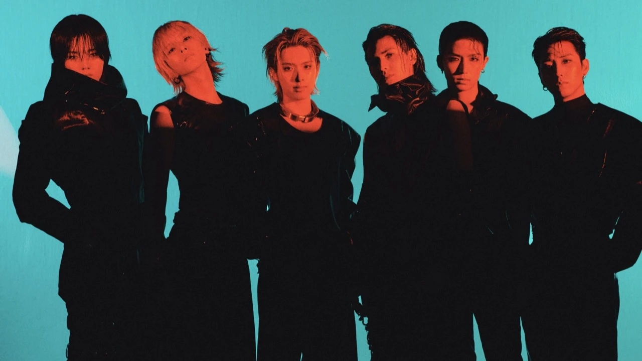 Xdinary Heroes in a dark studio portrait with a teal background during The New Xcene era