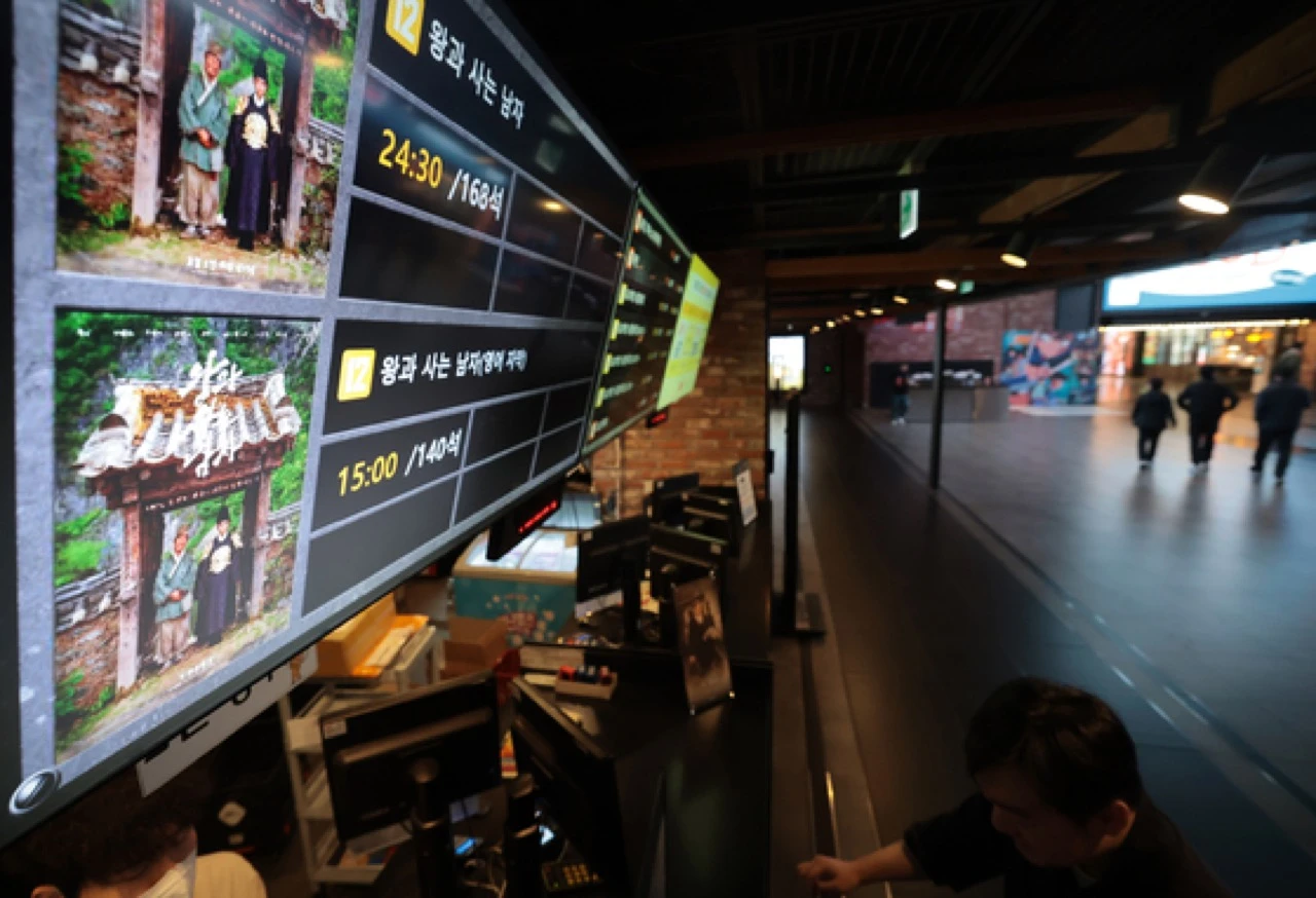 Showtime board and ticketing area inside a Seoul movie theater