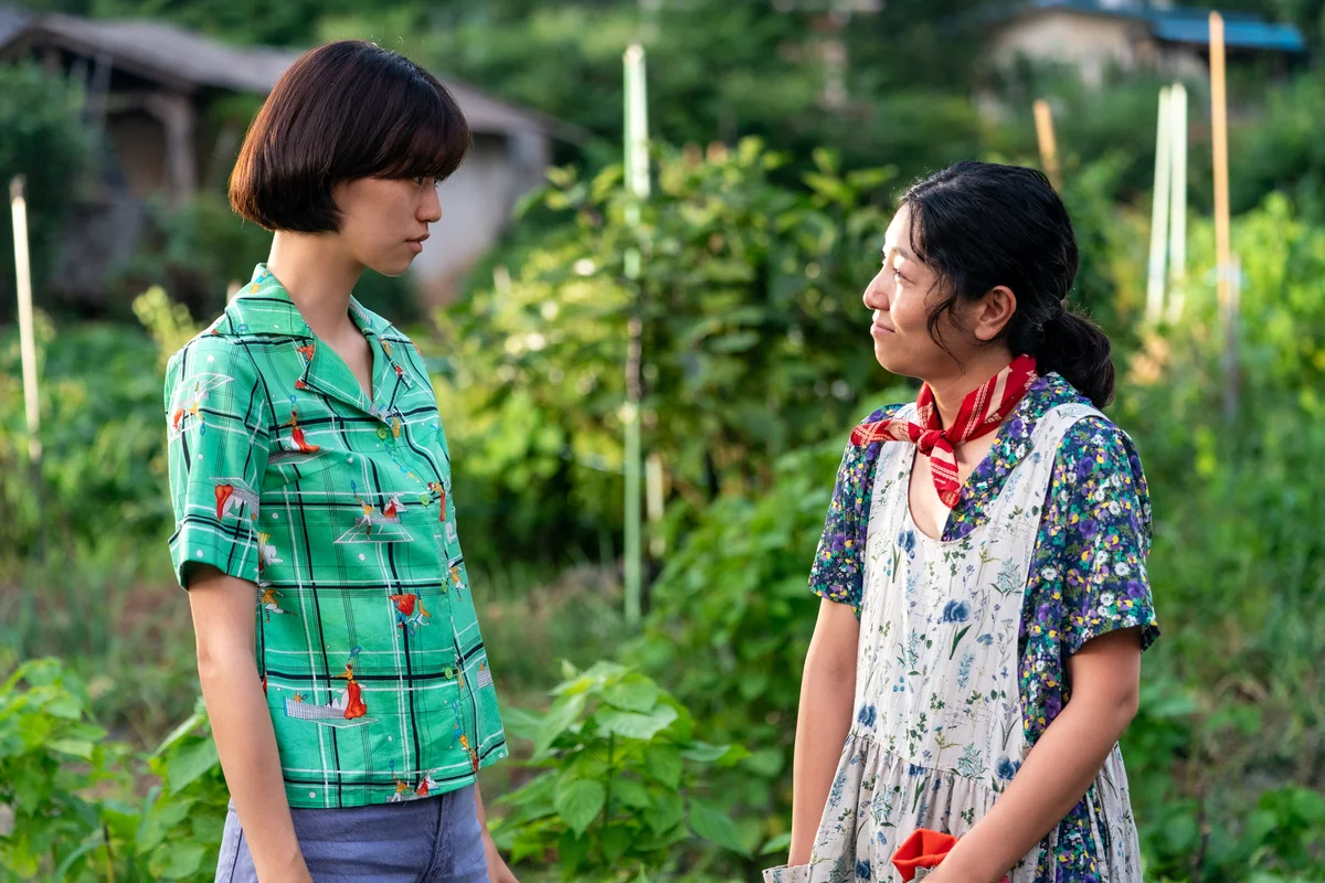 A still from Dora showing two women in a rural outdoor setting