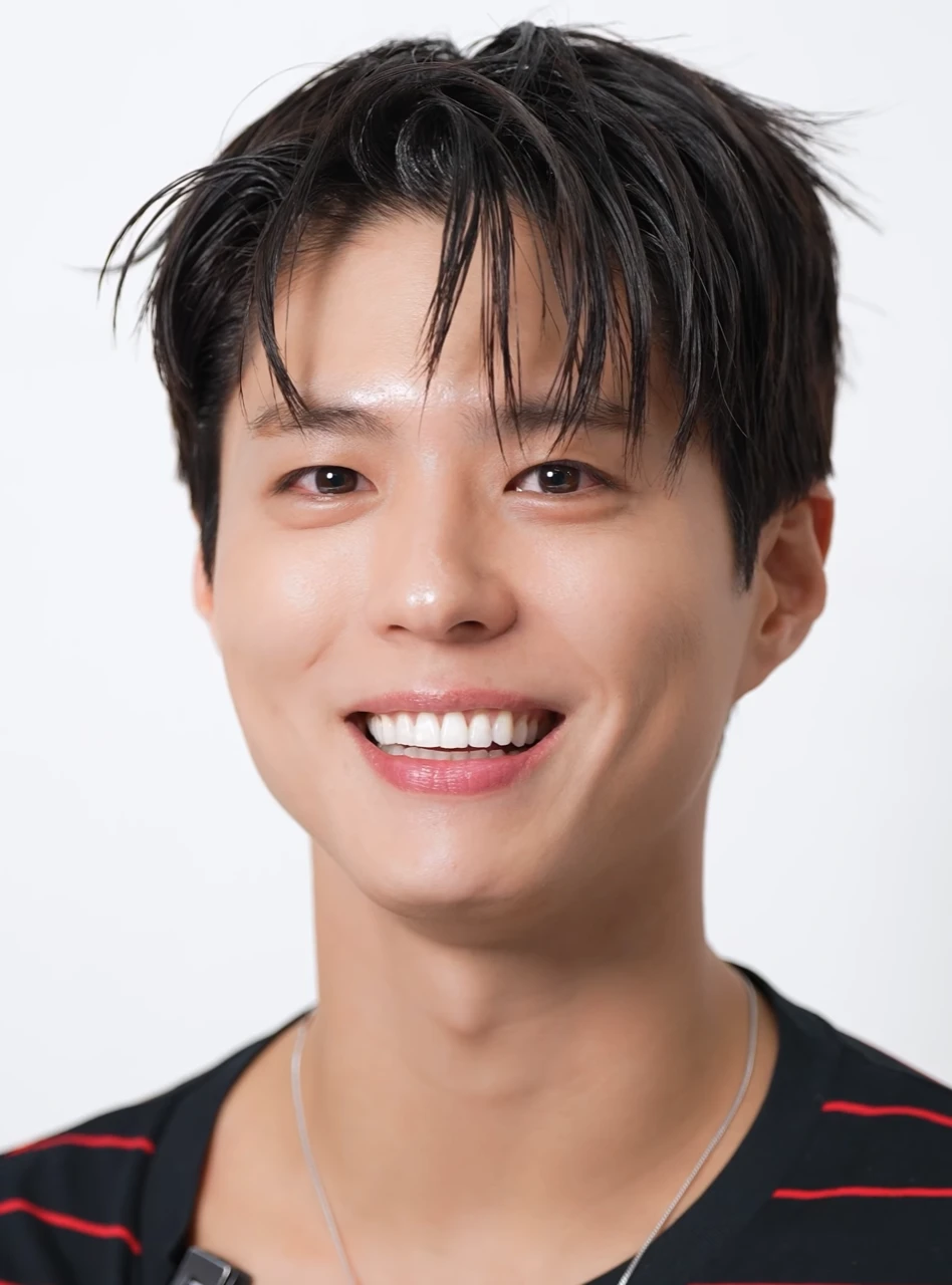 Park Bo Gum smiling in a studio portrait