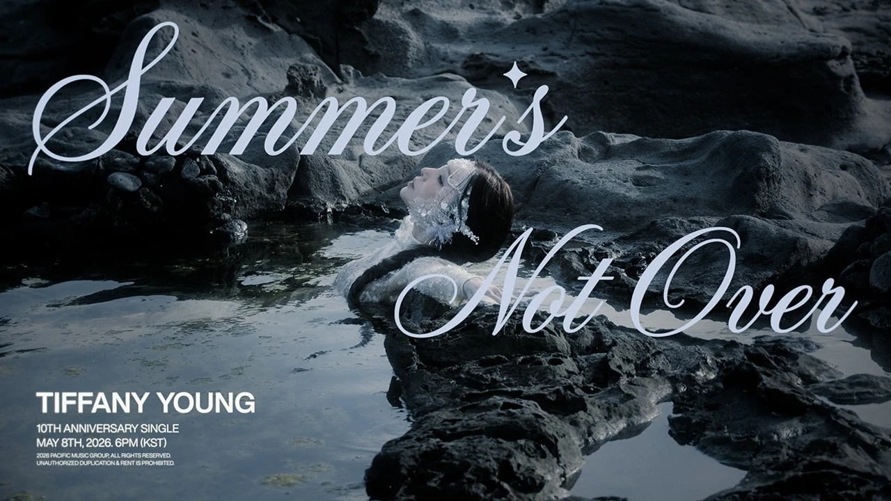 Promotional teaser image for Tiffany Young's Summer's Not Over showing her reclining on a rocky shore
