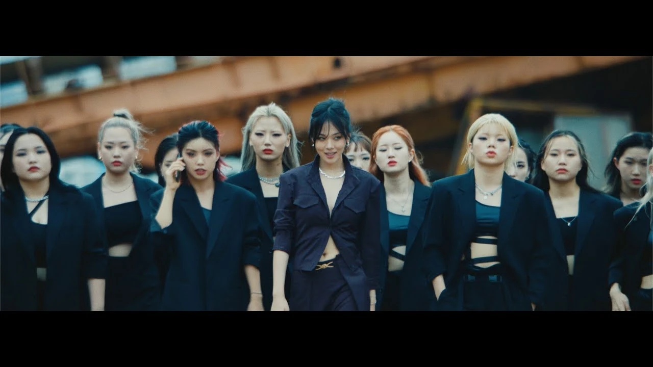 BIBI leads a dark suited performance formation in the official Vengeance music video visual