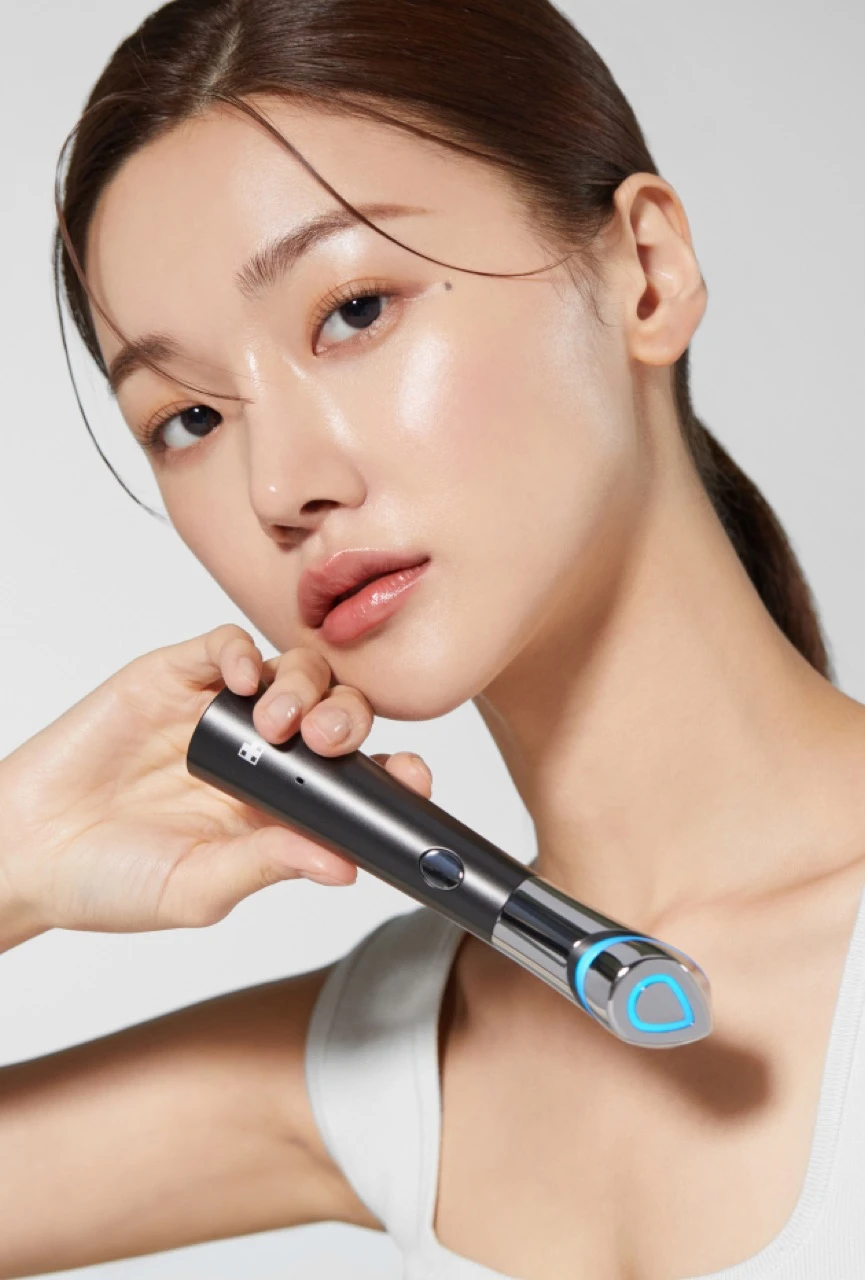 A model poses with a handheld Medicube-style skincare device in APR campaign imagery.