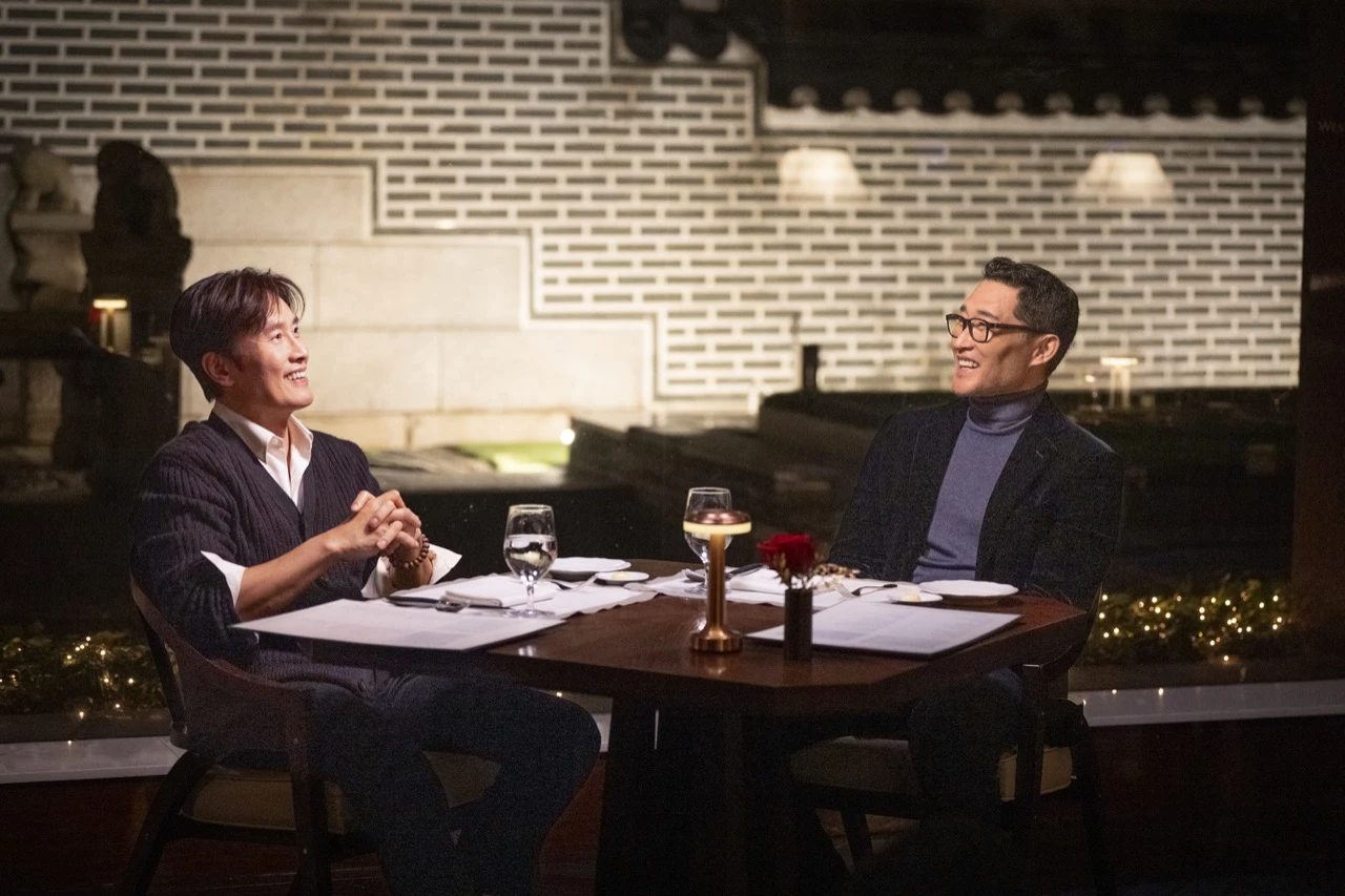 Daniel Dae Kim and Lee Byung-hun seated together during filming for CNN's K-Everything