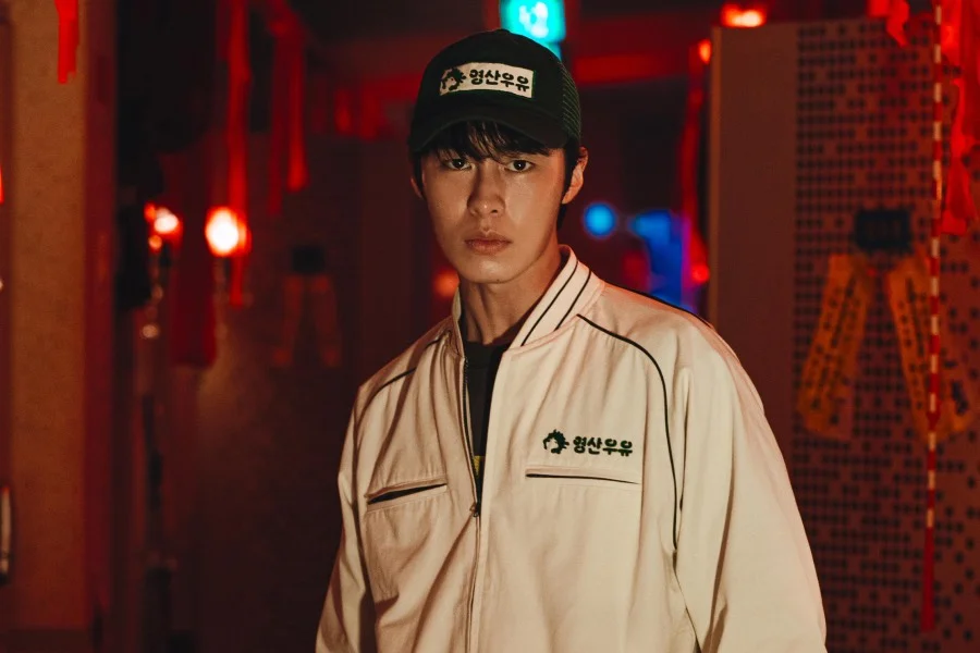 Lee Jae-wook in a dark work uniform in a still from Dead-End Job