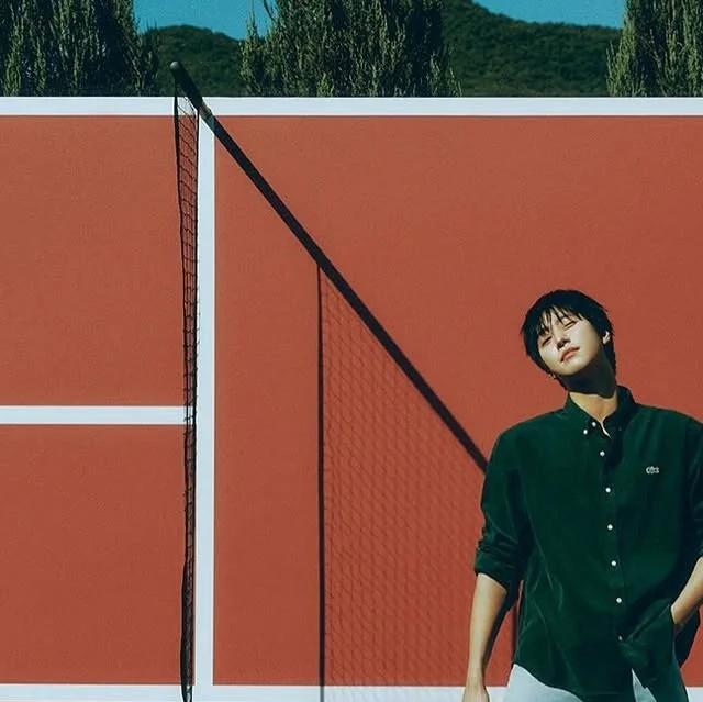 Ahn Hyo-seop in a fashion-style portrait shared on Instagram beside a tennis court.