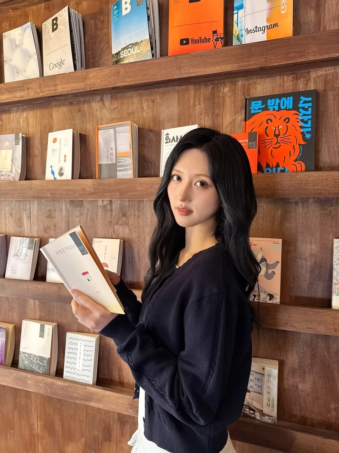 A reading-themed promotional image shows a woman holding an open book in front of bookstore shelves.