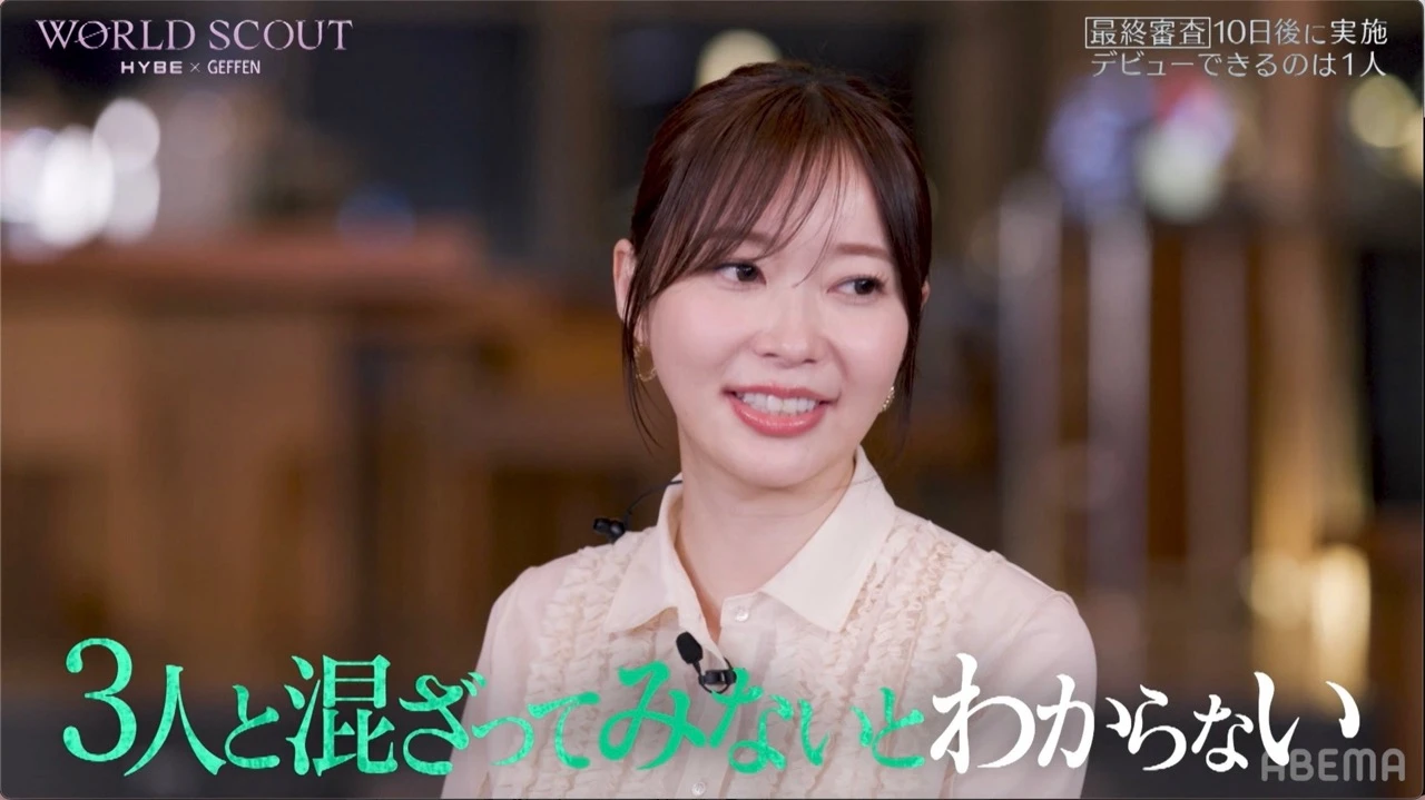 A broadcast still from World Scout: The Final Piece showing a contestant speaking during an ABEMA segment