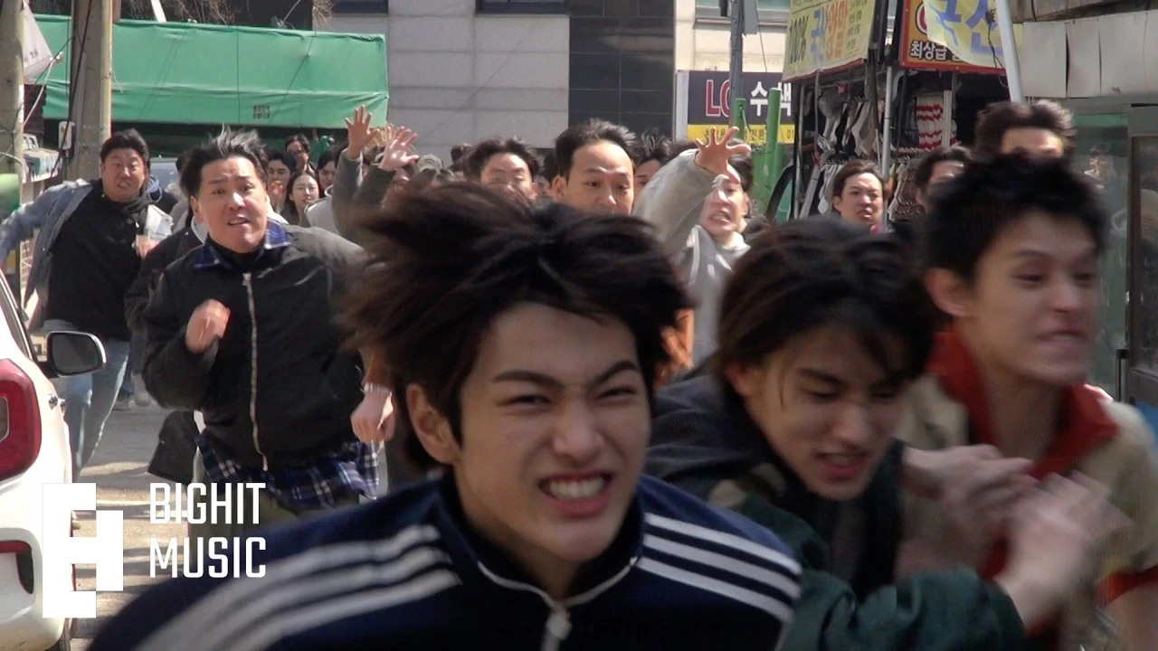 CORTIS running through a crowded street in a still from the official TNT music video