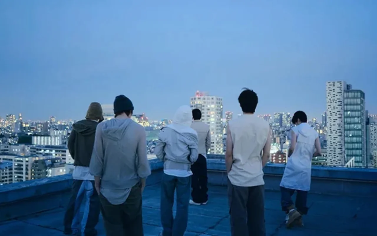 RIIZE members standing on a rooftop at dusk in teaser imagery tied to the group's II comeback rollout